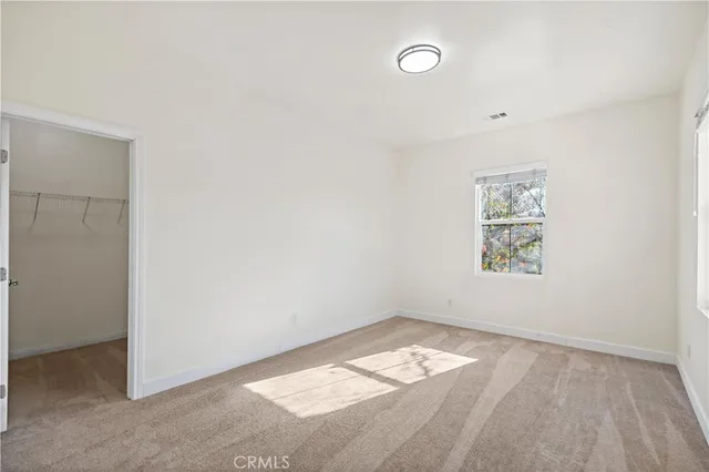 a spacious bathroom with a granite countertop sink a mirror and a bathtub