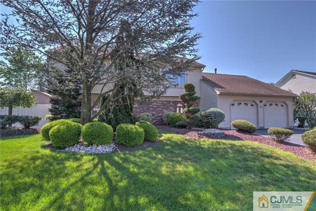 12 Higgins Road Old Bridge, NJ 08857 - Photo 2 of 25 a view of a backyard with table and chairs potted plants and large tree