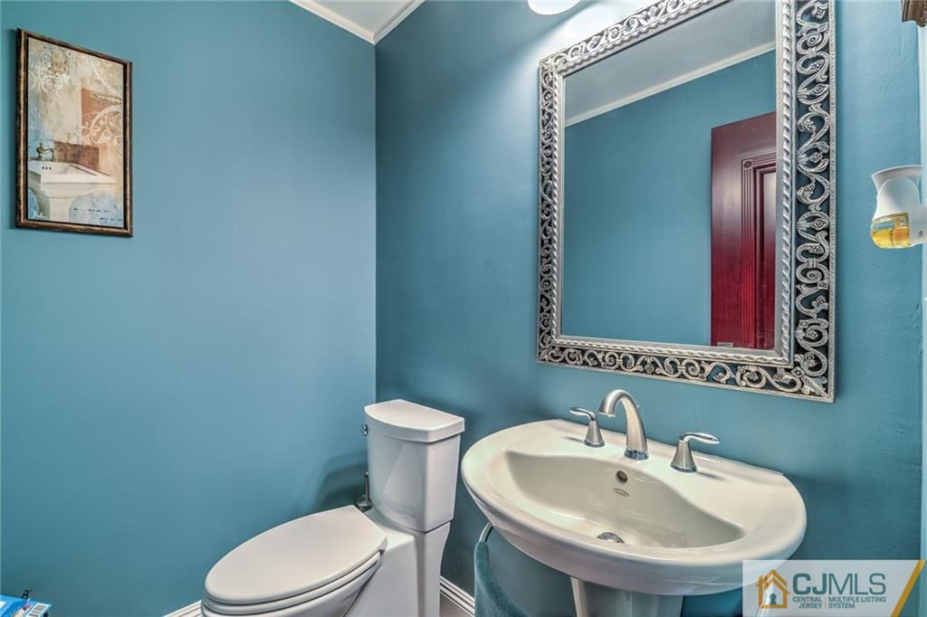 12 Higgins Road Old Bridge, NJ 08857 - Photo 12 of 25 a bathroom with a sink a toilet and mirror
