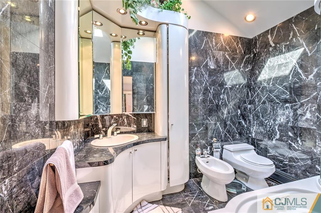 12 Higgins Road Old Bridge, NJ 08857 - Photo 14 of 25 a bathroom with a granite countertop toilet sink and shower