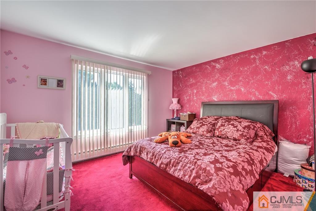 12 Higgins Road Old Bridge, NJ 08857 - Photo 16 of 25 a bed room with a bed and a chair
