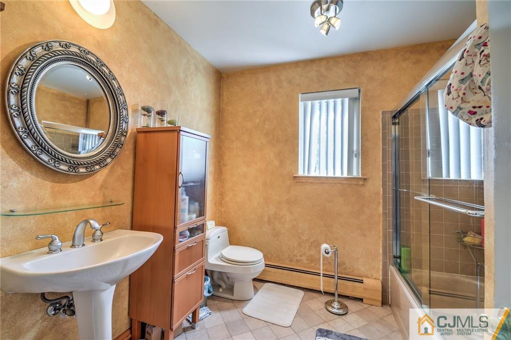 12 Higgins Road Old Bridge, NJ 08857 - Photo 19 of 25 a bathroom with a sink a toilet and mirror