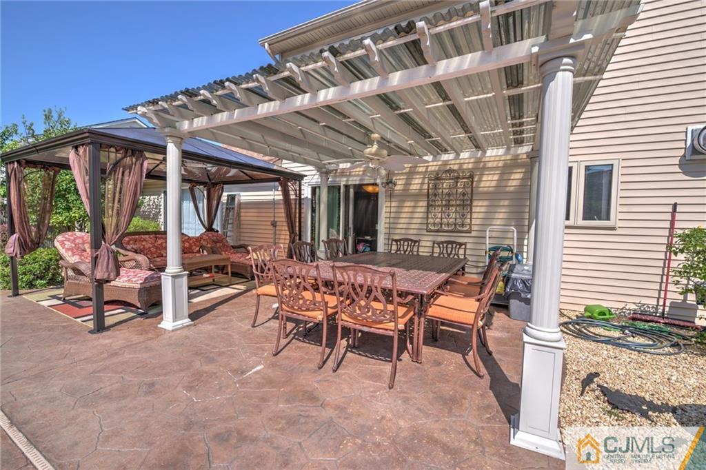 12 Higgins Road Old Bridge, NJ 08857 - Photo 20 of 25 a view of a patio with table and chairs and potted plants