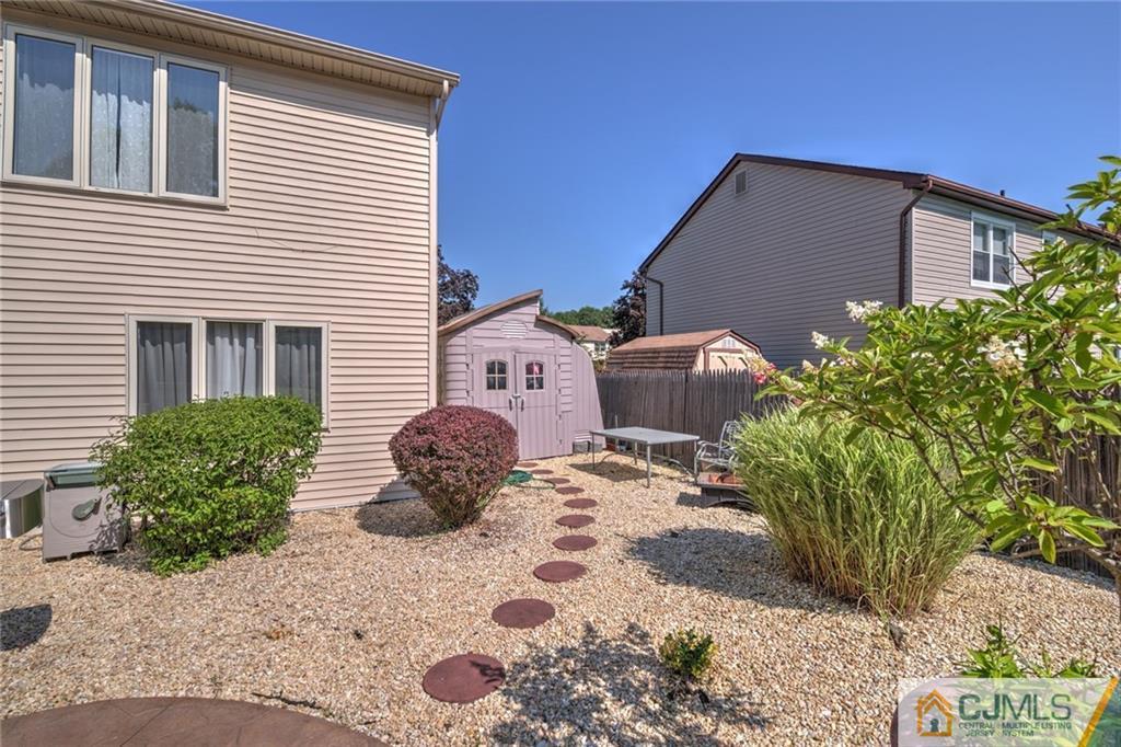 12 Higgins Road Old Bridge, NJ 08857 - Photo 24 of 25 a backyard of a house with potted plants