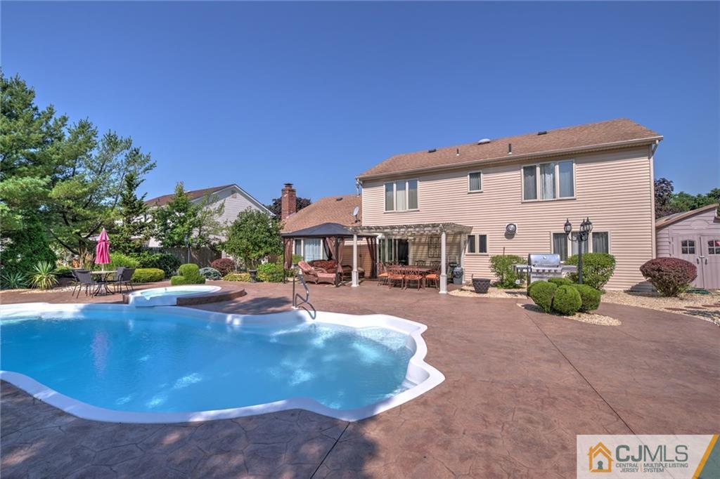 12 Higgins Road Old Bridge, NJ 08857 - Photo 25 of 25 a view of a house with swimming pool and sitting area
