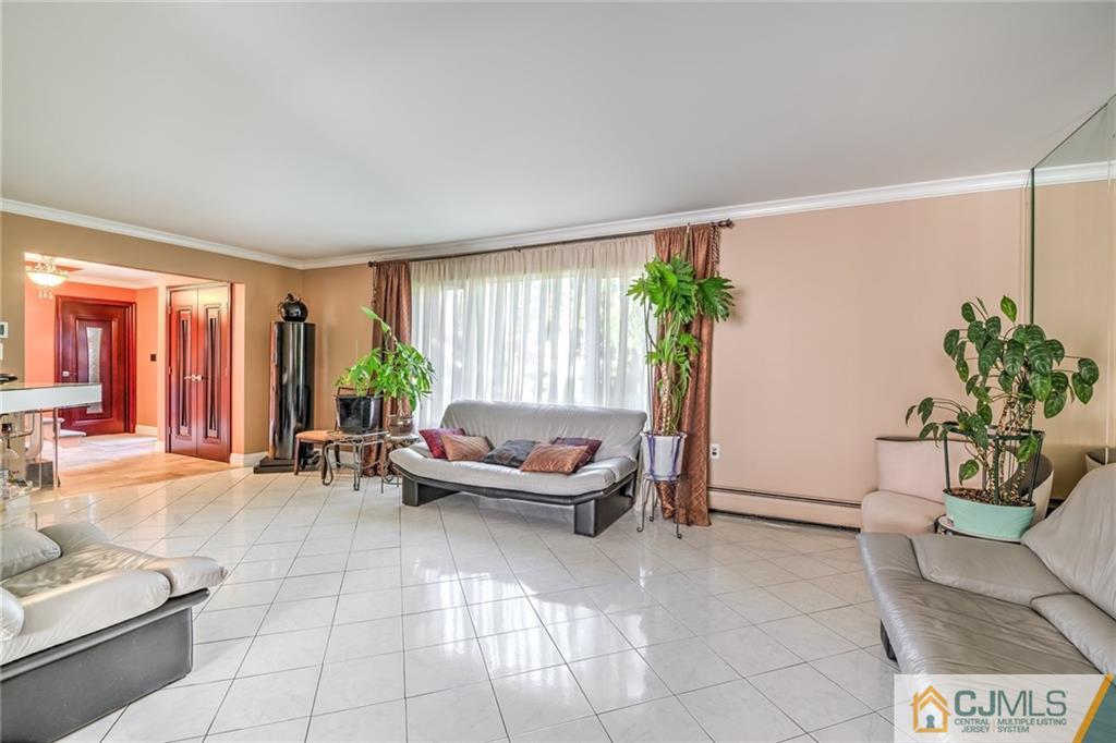 12 Higgins Road Old Bridge, NJ 08857 - Photo 6 of 25 a living room with furniture and a large window