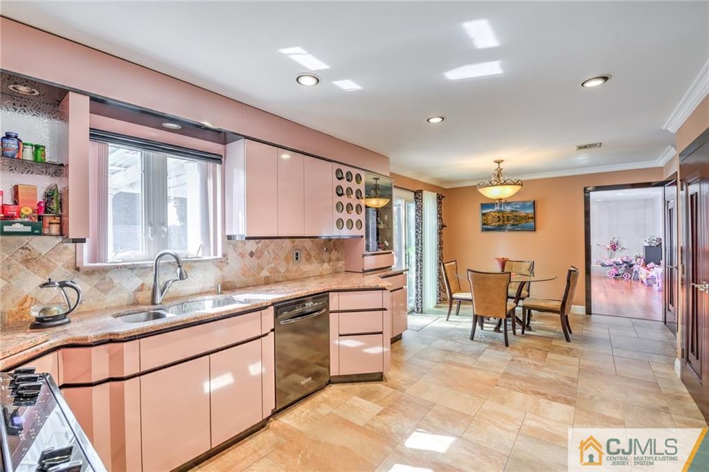 12 Higgins Road Old Bridge, NJ 08857 - Photo 10 of 25 a large kitchen with kitchen island a sink and a large window