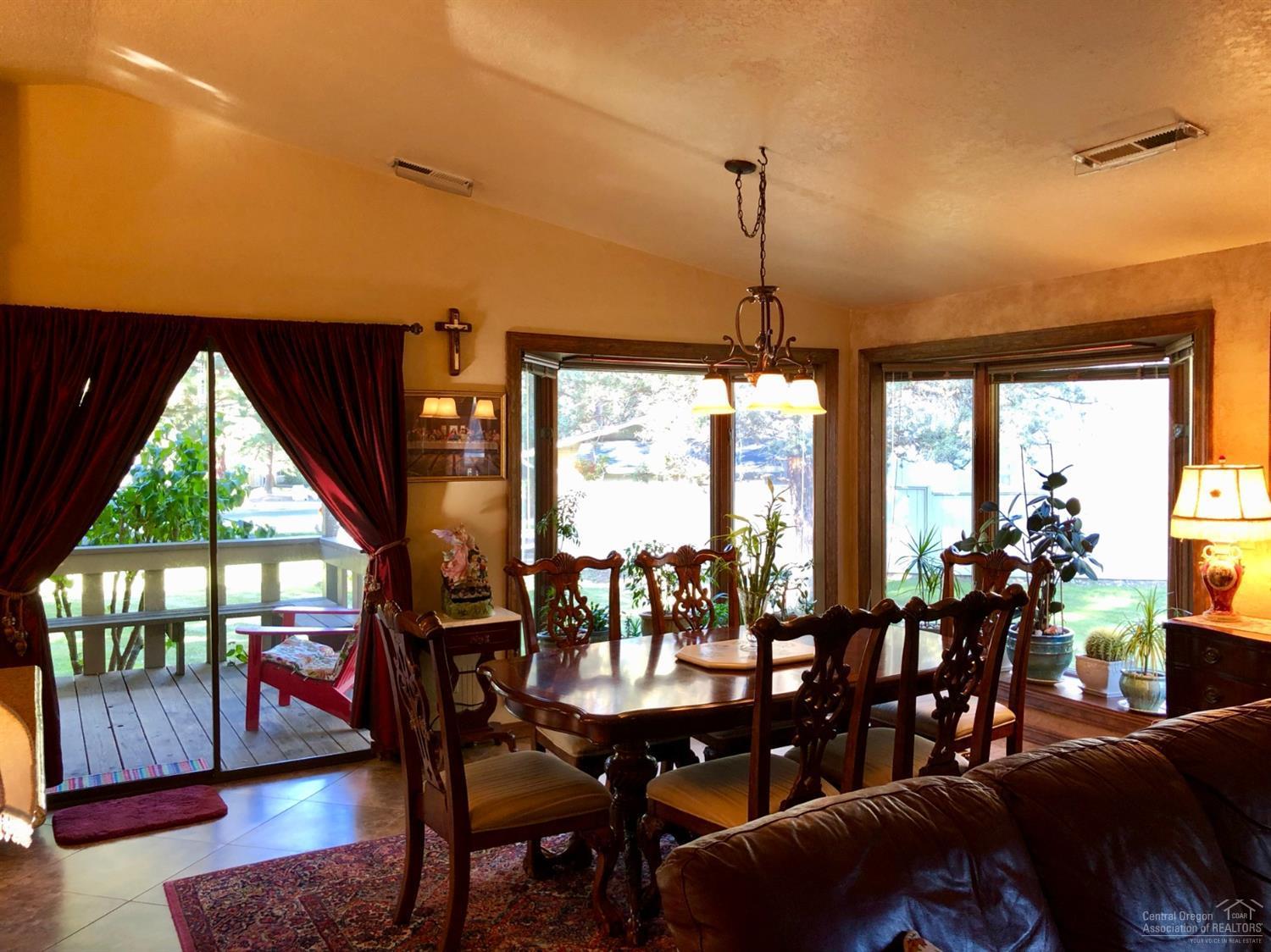 20416 Bullblock Road Bend, OR 97702 - Photo 7 of 23 a view of a dining room with furniture window and wooden floor