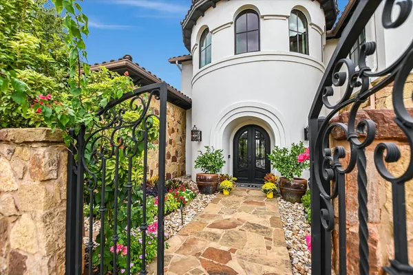 a view of a door of the house with potted plants