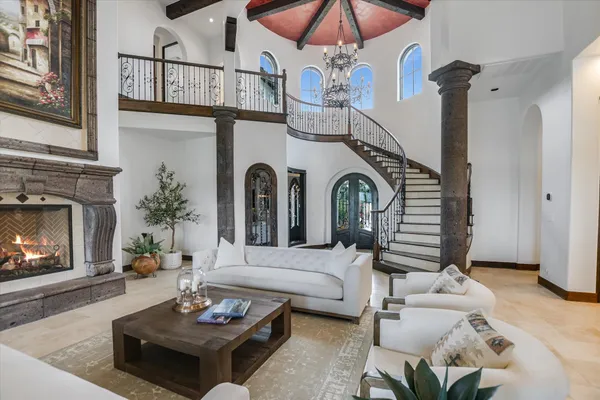 a living room with furniture and a chandelier