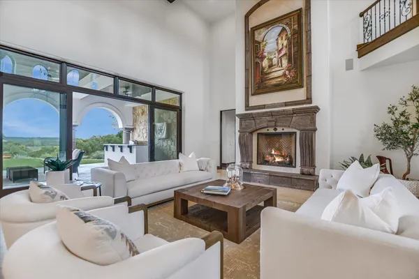 a kitchen with stainless steel appliances granite countertop a stove top oven a sink a dining table and chairs