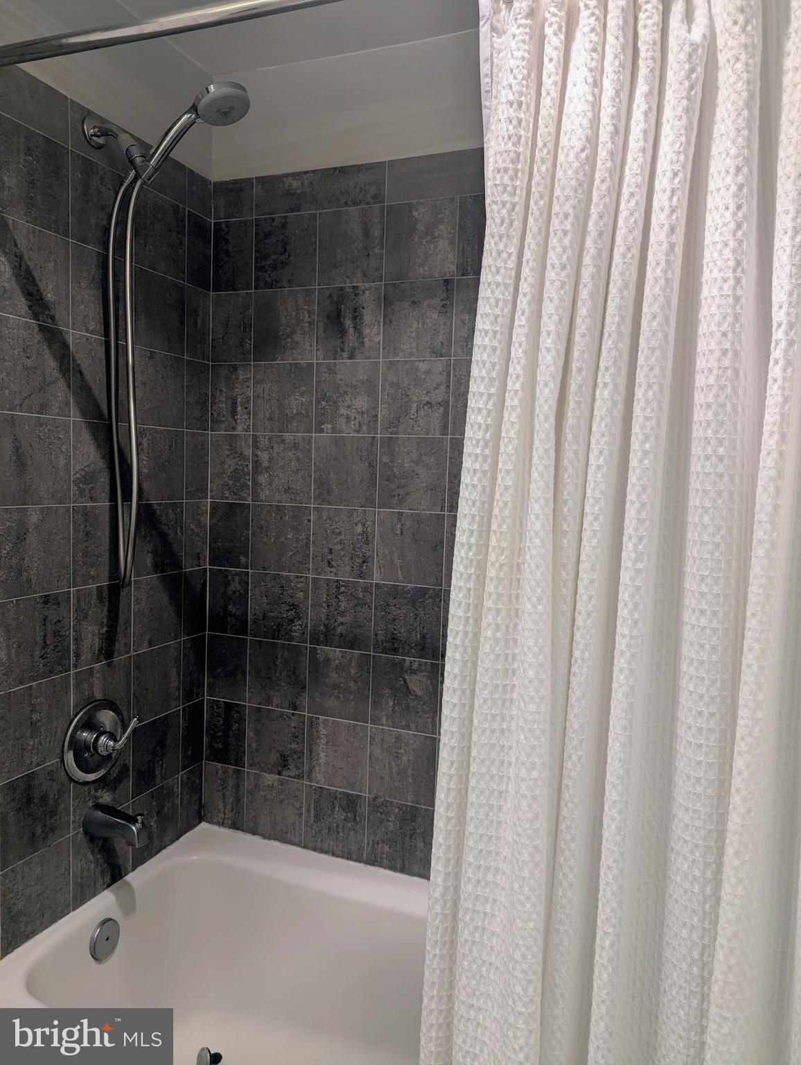 1701 16th Street Northwest, Unit 510 Washington, DC 20009 - Photo 17 of 29 Travertine shower/tub combo