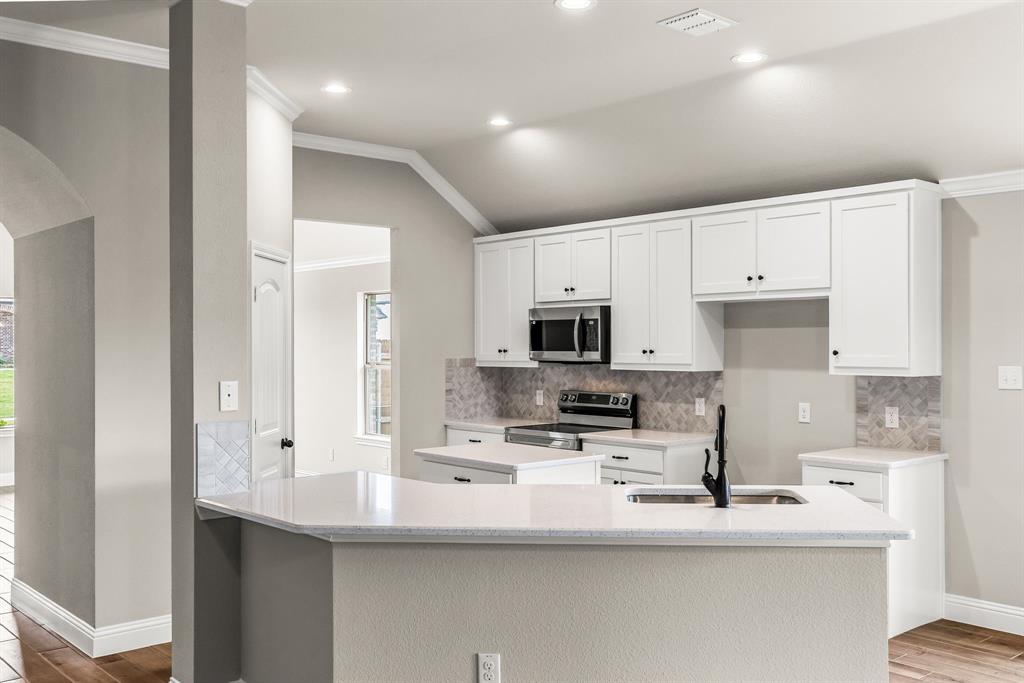 314 Pennington Road Josephine, TX 75173 - Photo 26 of 37 a kitchen with stainless steel appliances a sink a stove a microwave a refrigerator and cabinets