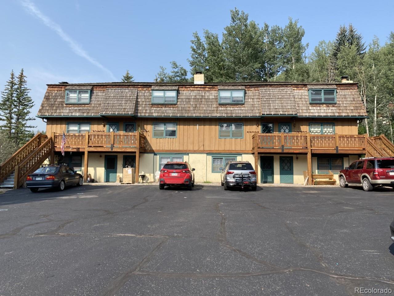 a view of a cars park in front of a building