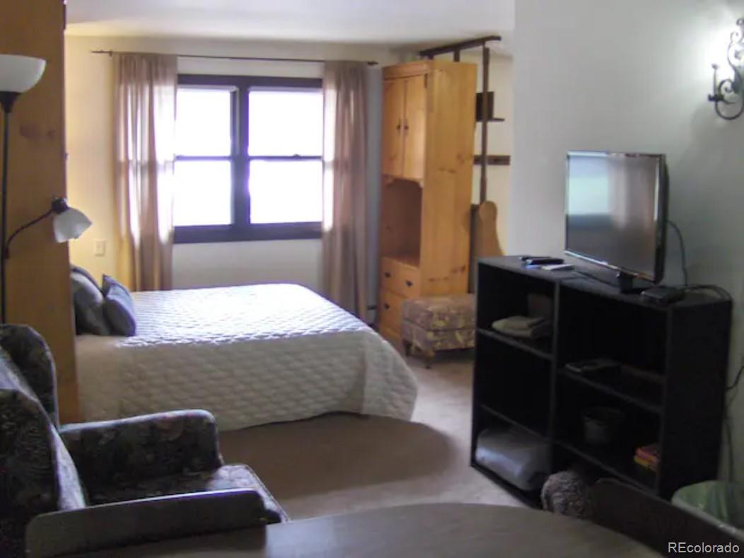 2469 Chamonix Lane, Unit E4 Vail, CO 81657 - Photo 12 of 24 a bedroom with a bed and a window