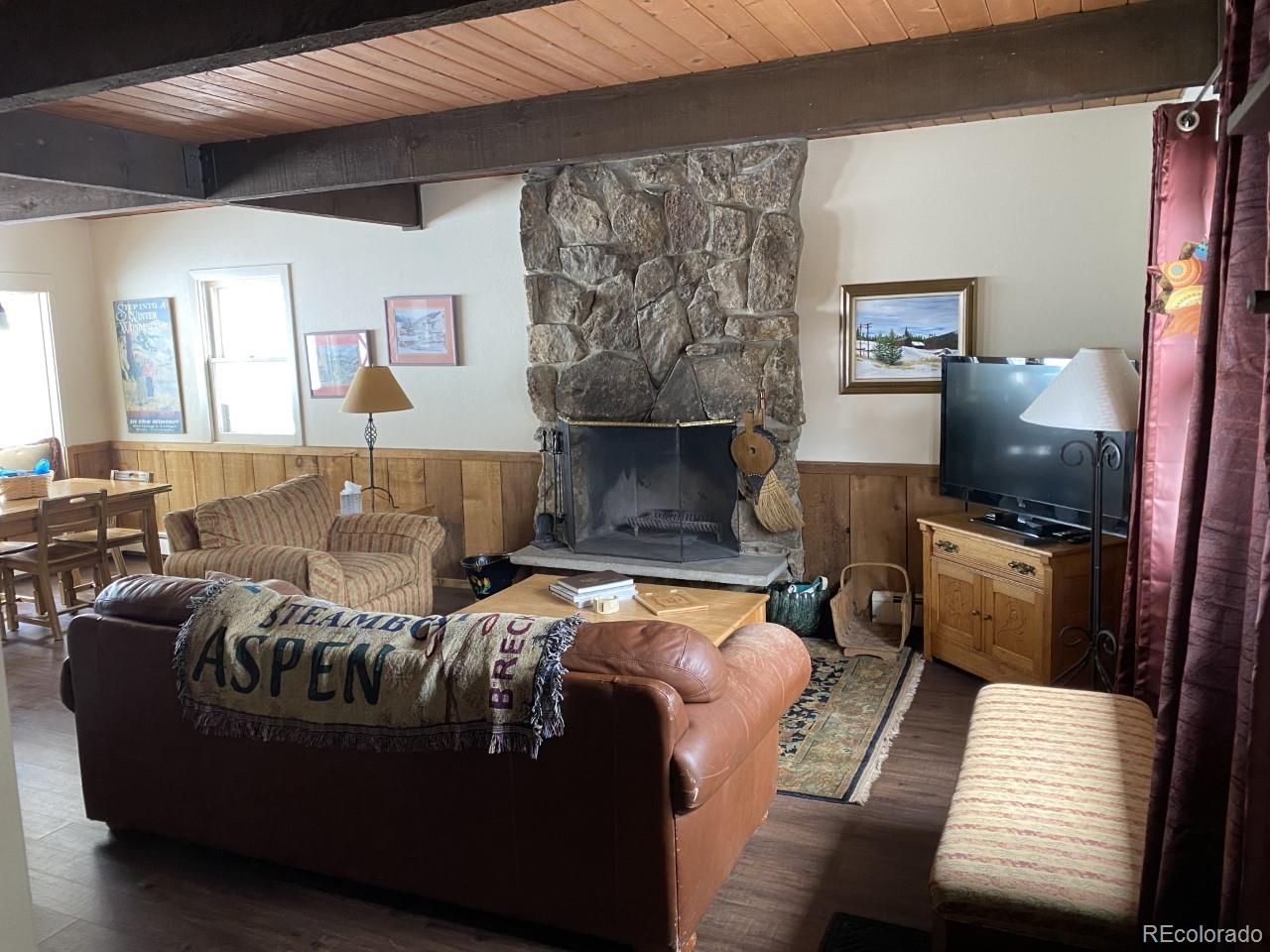 2469 Chamonix Lane, Unit E4 Vail, CO 81657 - Photo 4 of 24 a living room with furniture and a fireplace