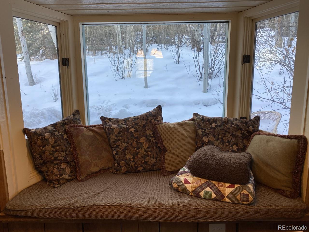 2469 Chamonix Lane, Unit E4 Vail, CO 81657 - Photo 7 of 24 a living room with furniture and a floor to ceiling window