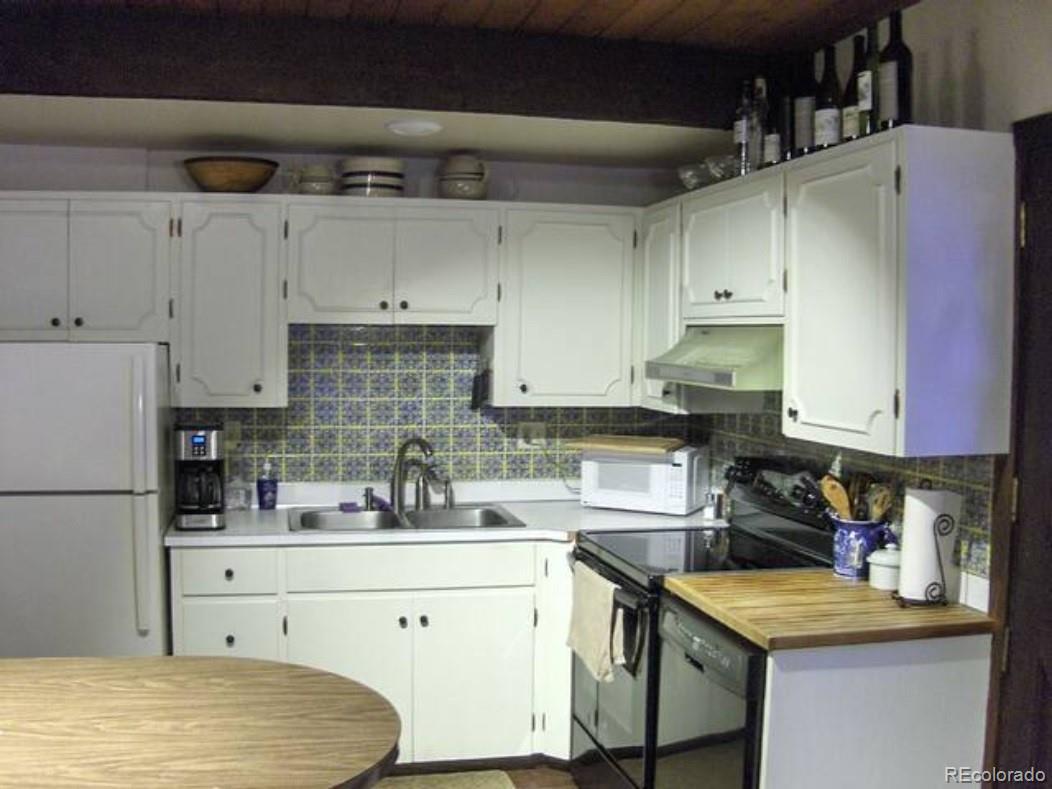 2469 Chamonix Lane, Unit E4 Vail, CO 81657 - Photo 8 of 24 a kitchen with a sink a stove and cabinets