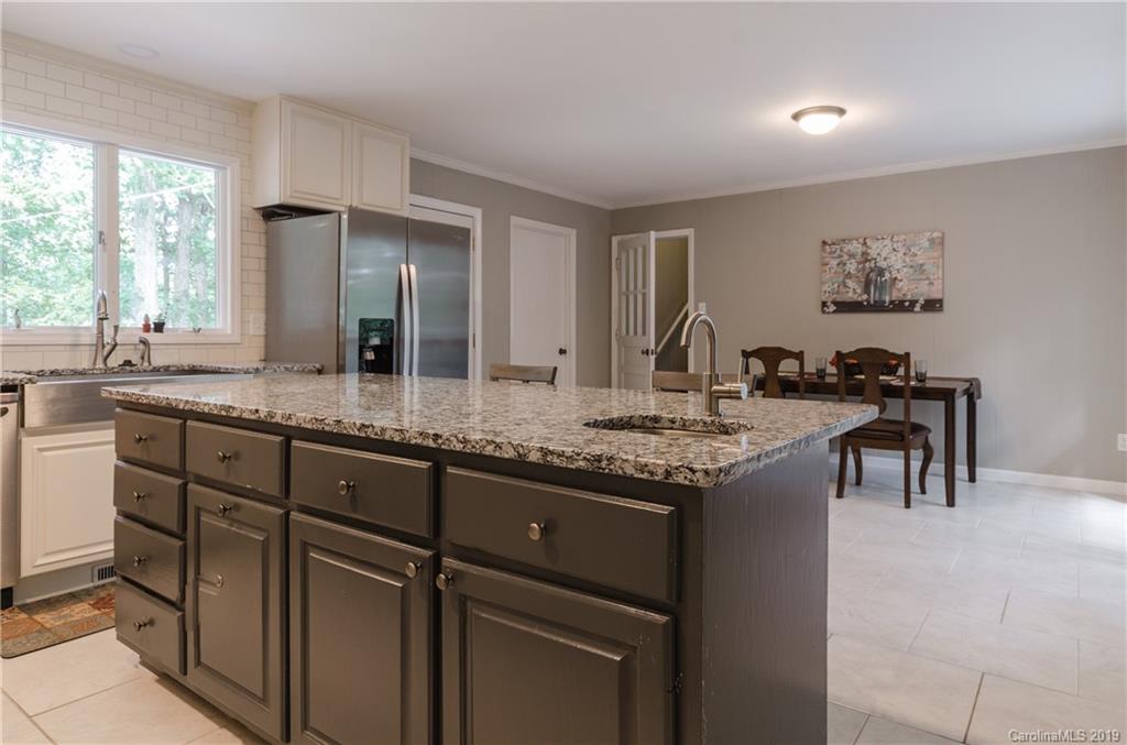 3614 Medlin Road Monroe, NC 28112 - Photo 14 of 33 a kitchen with granite countertop a sink and cabinets