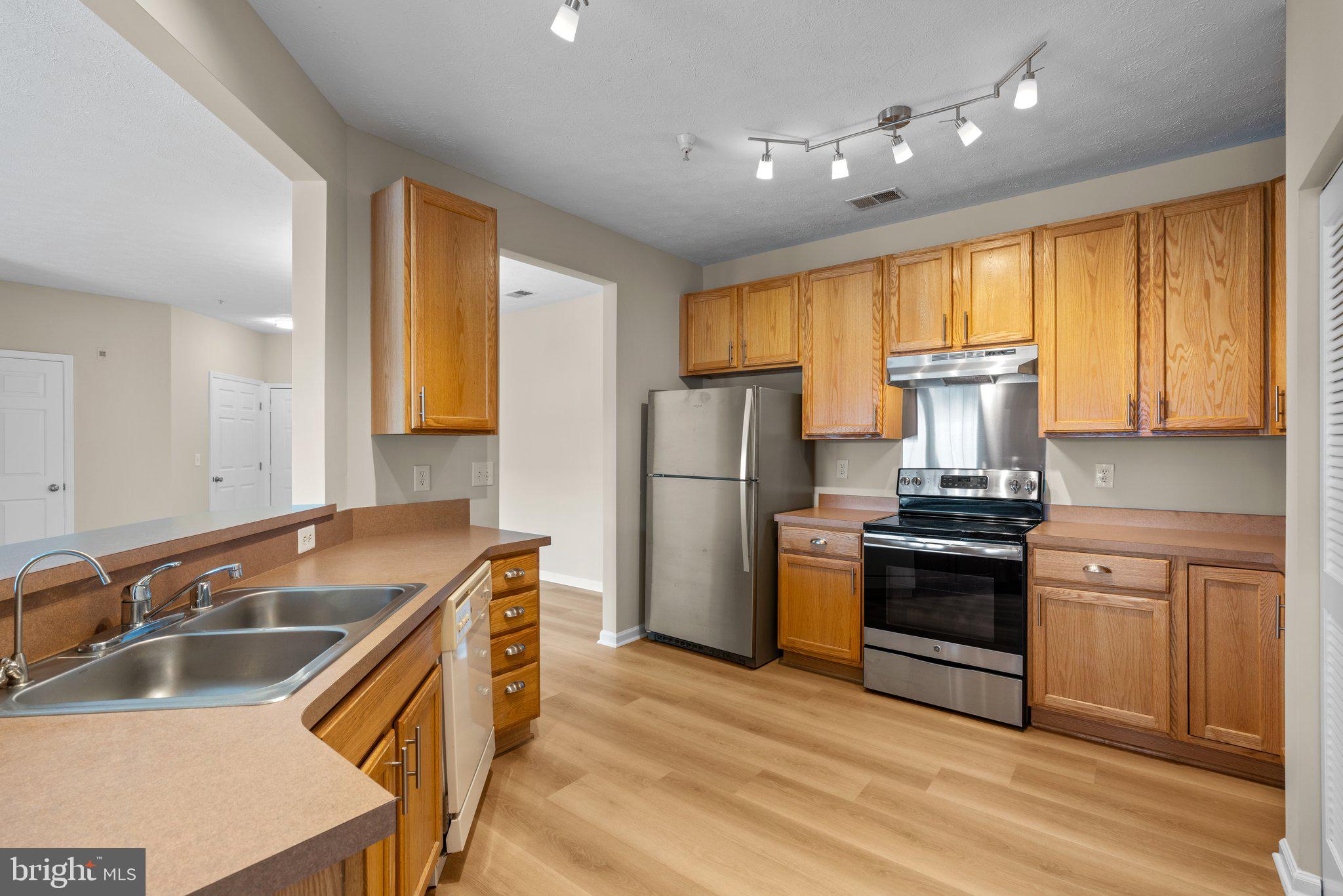 5458 Glenthorne Court, Unit 5458 Baltimore, MD 21237 - Photo 14 of 32 a kitchen with stainless steel appliances granite countertop a sink stove and refrigerator