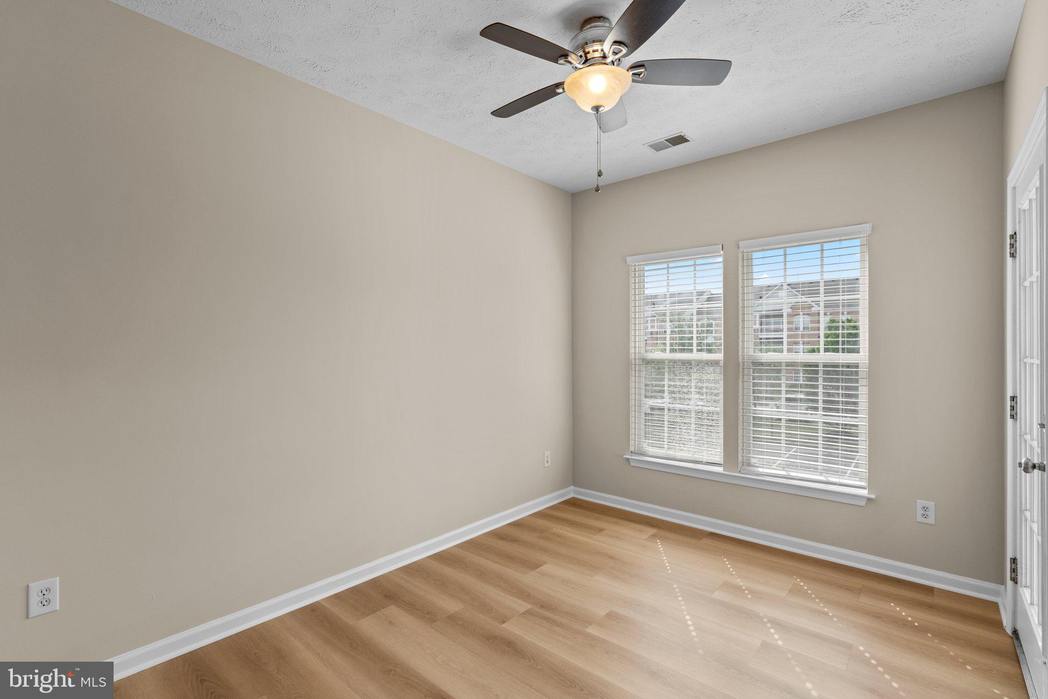 5458 Glenthorne Court, Unit 5458 Baltimore, MD 21237 - Photo 15 of 32 an empty room with a window and a fan