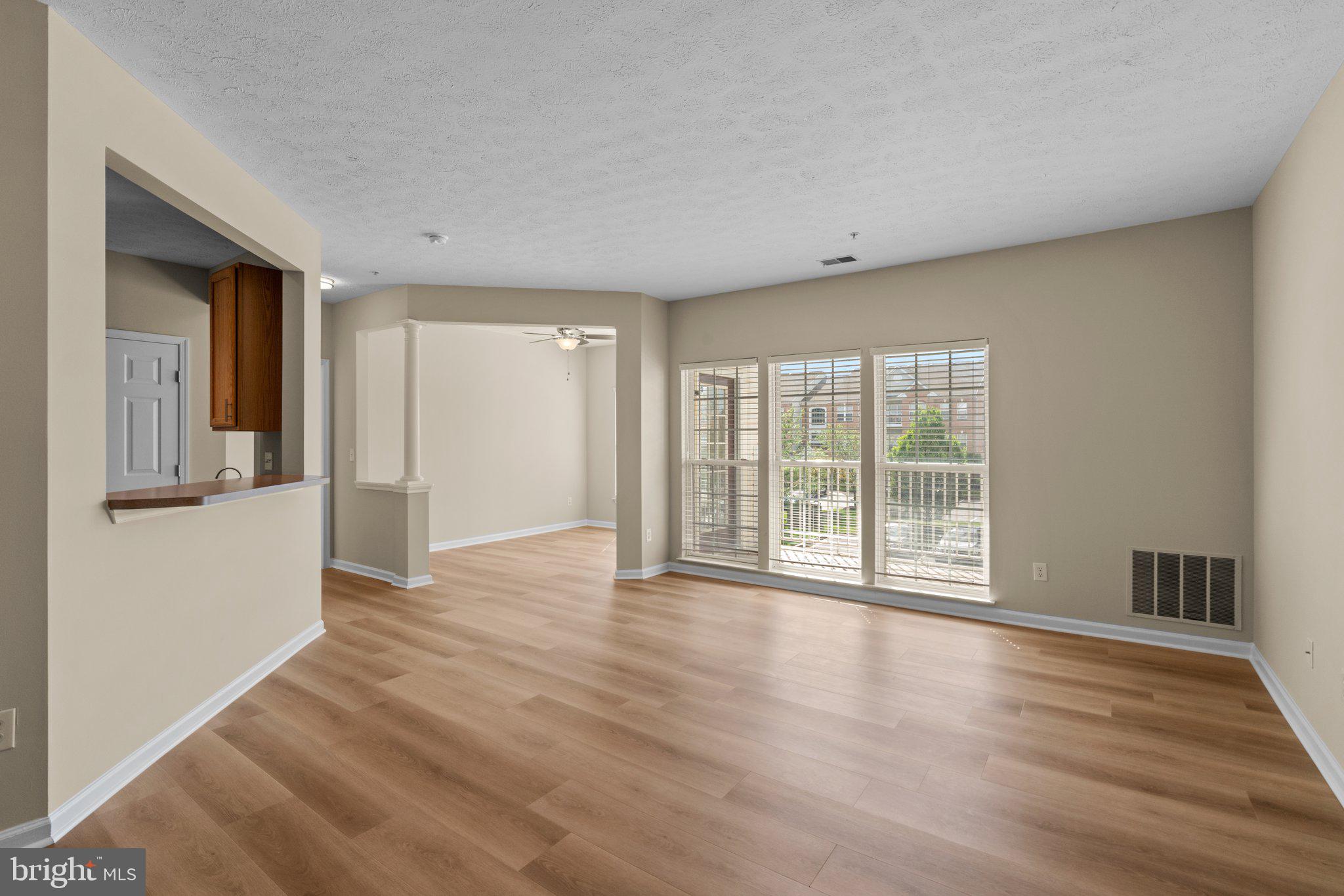 5458 Glenthorne Court, Unit 5458 Baltimore, MD 21237 - Photo 2 of 32 a view of an empty room with wooden floor and a window