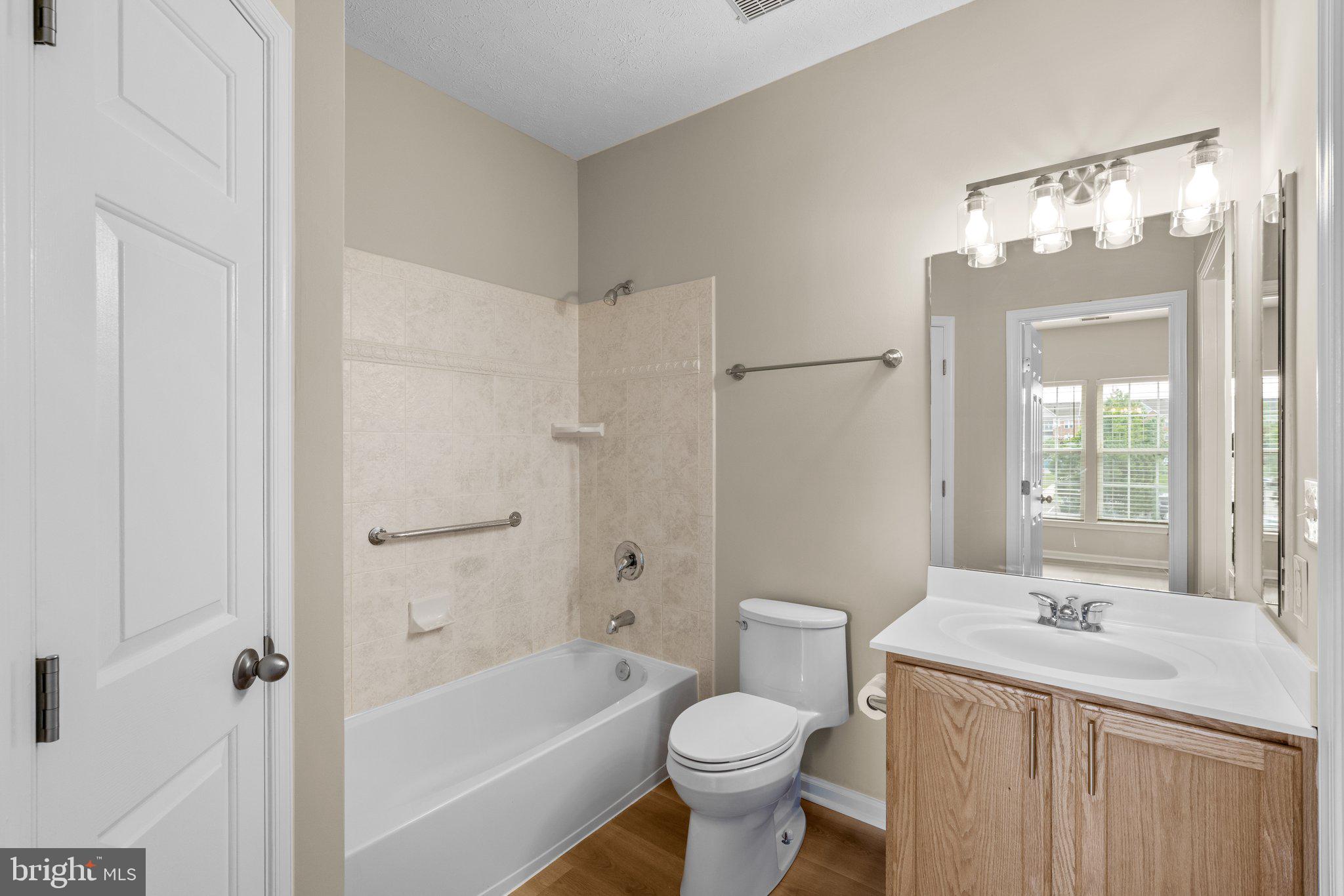 5458 Glenthorne Court, Unit 5458 Baltimore, MD 21237 - Photo 21 of 32 a bathroom with a sink toilet a shower and a mirror