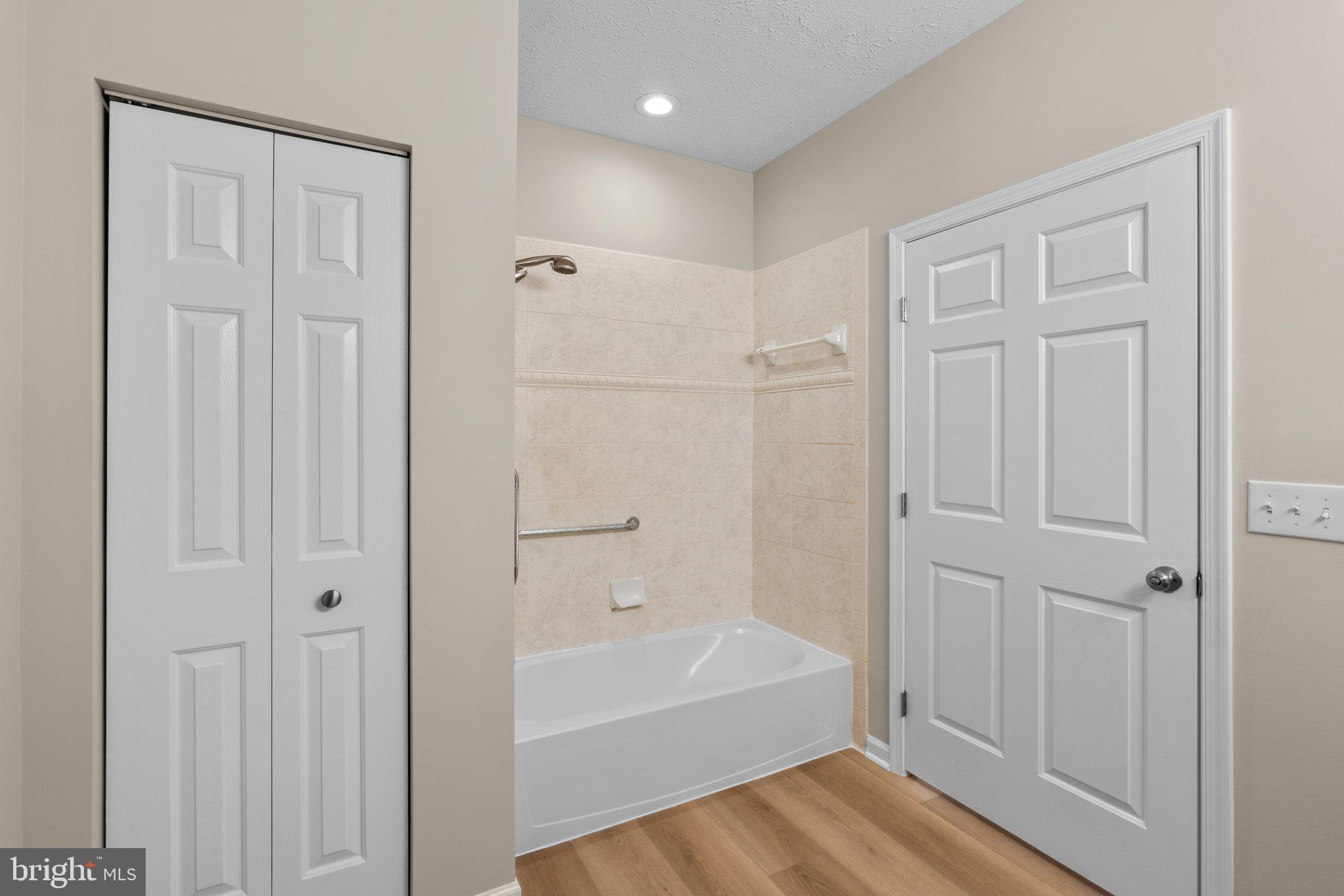 5458 Glenthorne Court, Unit 5458 Baltimore, MD 21237 - Photo 30 of 32 a bathroom with a bathtub and a shower