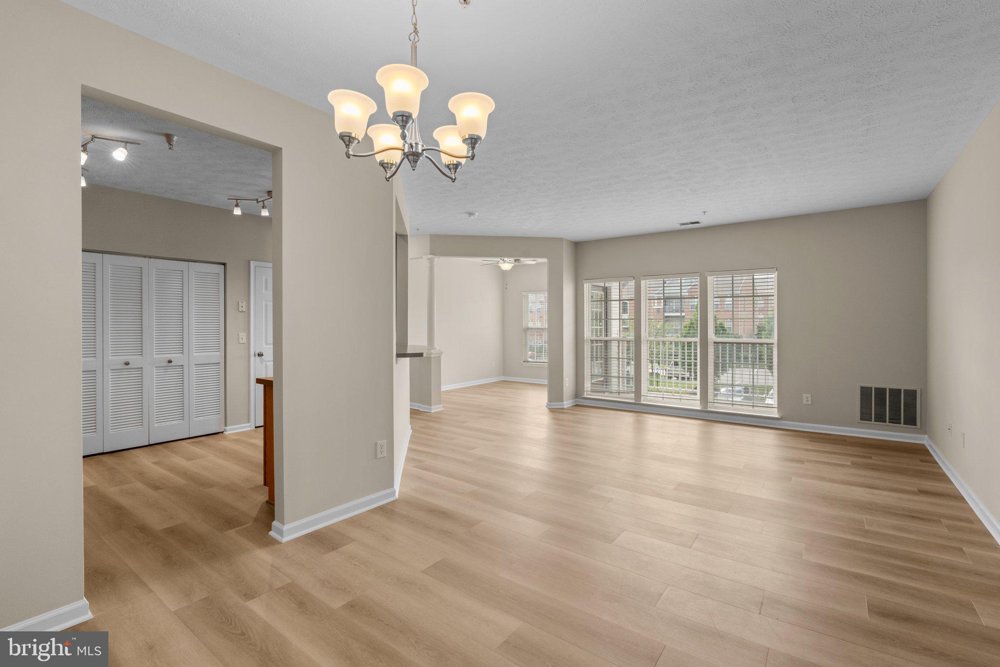5458 Glenthorne Court, Unit 5458 Baltimore, MD 21237 - Photo 7 of 32 a view of an empty room with a window and wooden floor