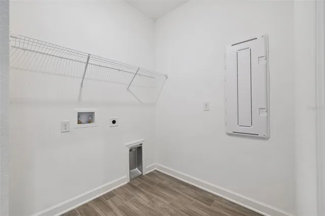 a view of a small space with wooden floor and a window