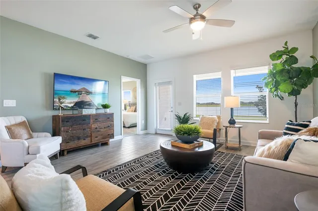 a living room with furniture potted plant and a table