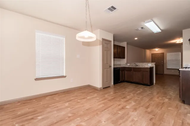 a view of a kitchen with a sink and a window