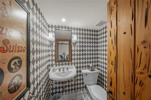 a living room with furniture a fireplace and large windows