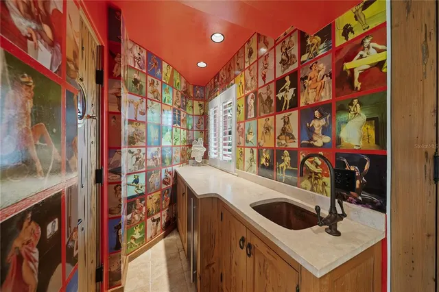 a bedroom with a large bed and windows