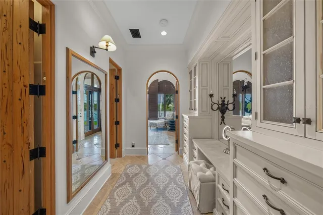 a view of staircase with railing and pendant lights