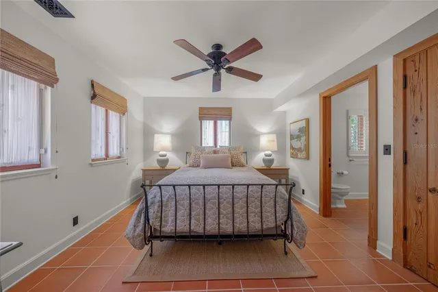 a room with a bed and a mirror on the dresser