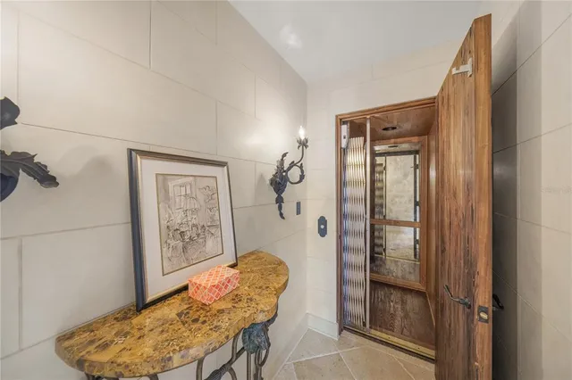 a bedroom with a bed a couch and a chandelier