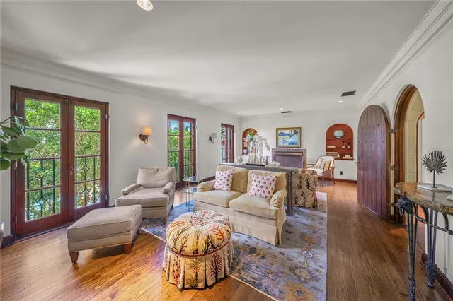 a view of swimming pool with outdoor seating and house in the background