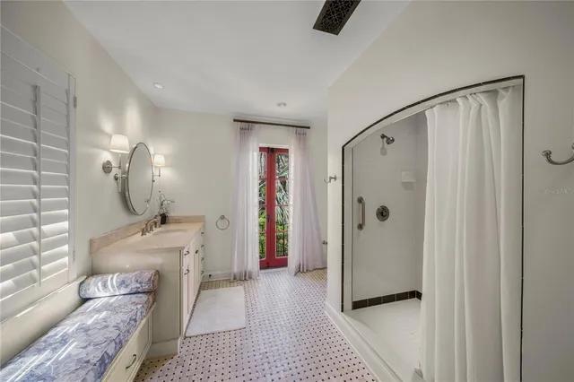 a front view of a house with a yard and potted plants