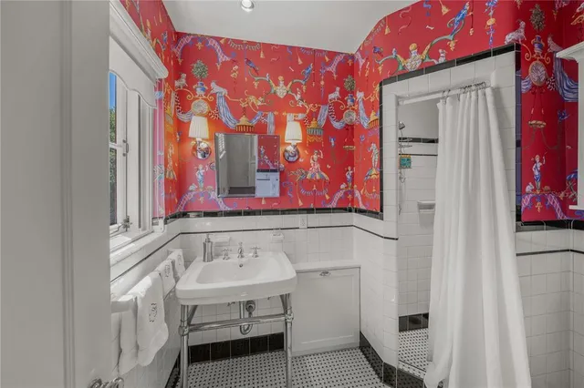 a view of swimming pool from a balcony with outdoor seating