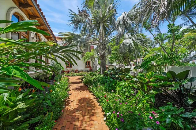 a view of swimming pool with outdoor seating and plants