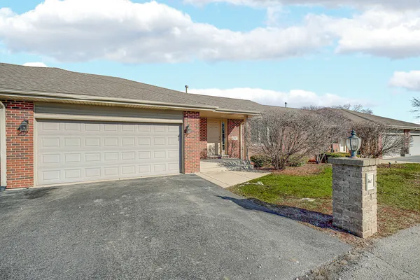 a view of a house with a yard and garage
