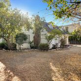 a view of a tree in front of a house