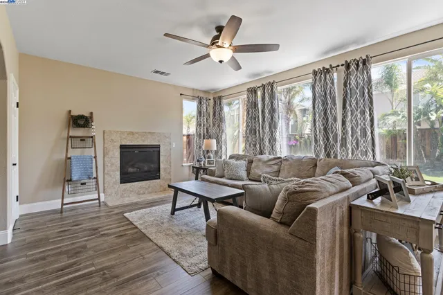 a view of an empty room with kitchen and a window