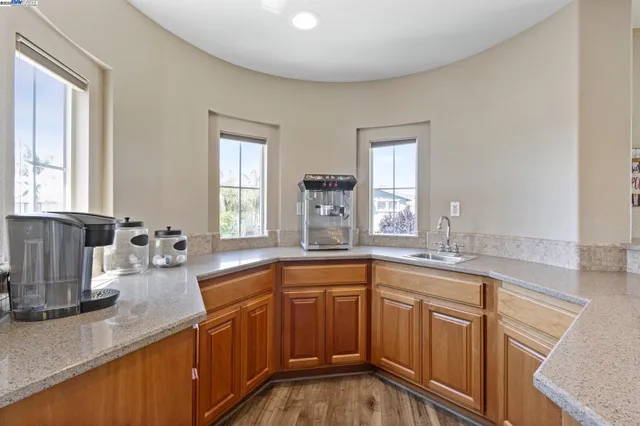 a spacious bedroom with a bed and a chandelier