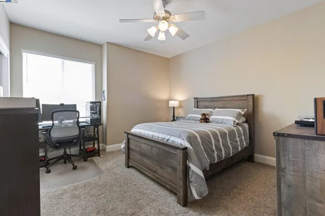 a bed sitting in a bedroom next to a window