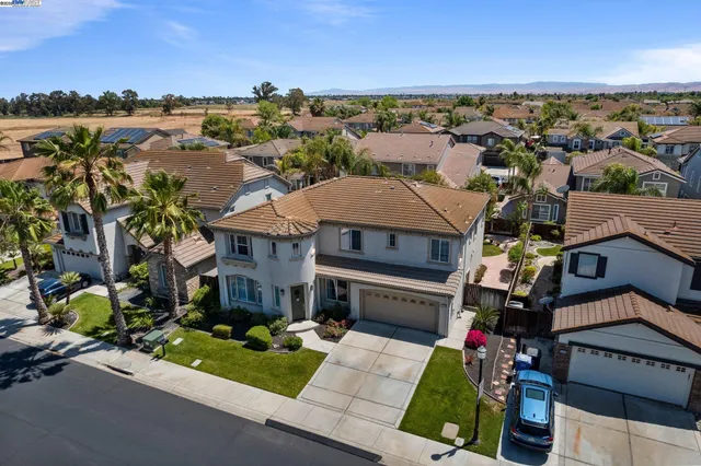 a view of a patio with dining table and chairs under an umbrella