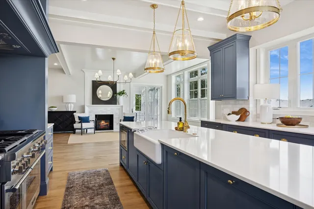 a kitchen with a sink a stove and cabinets