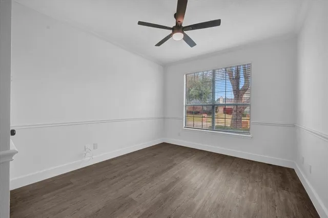 a view of a big room with wooden floor a ceiling fan and closet area