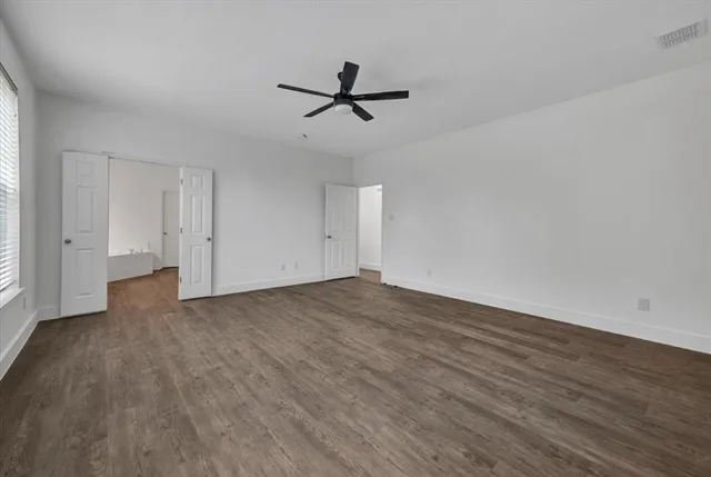 a view of a yard with a house and a large tree